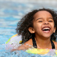 A young child swimming.