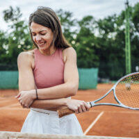 Woman who hurt her elbow while playing tennis