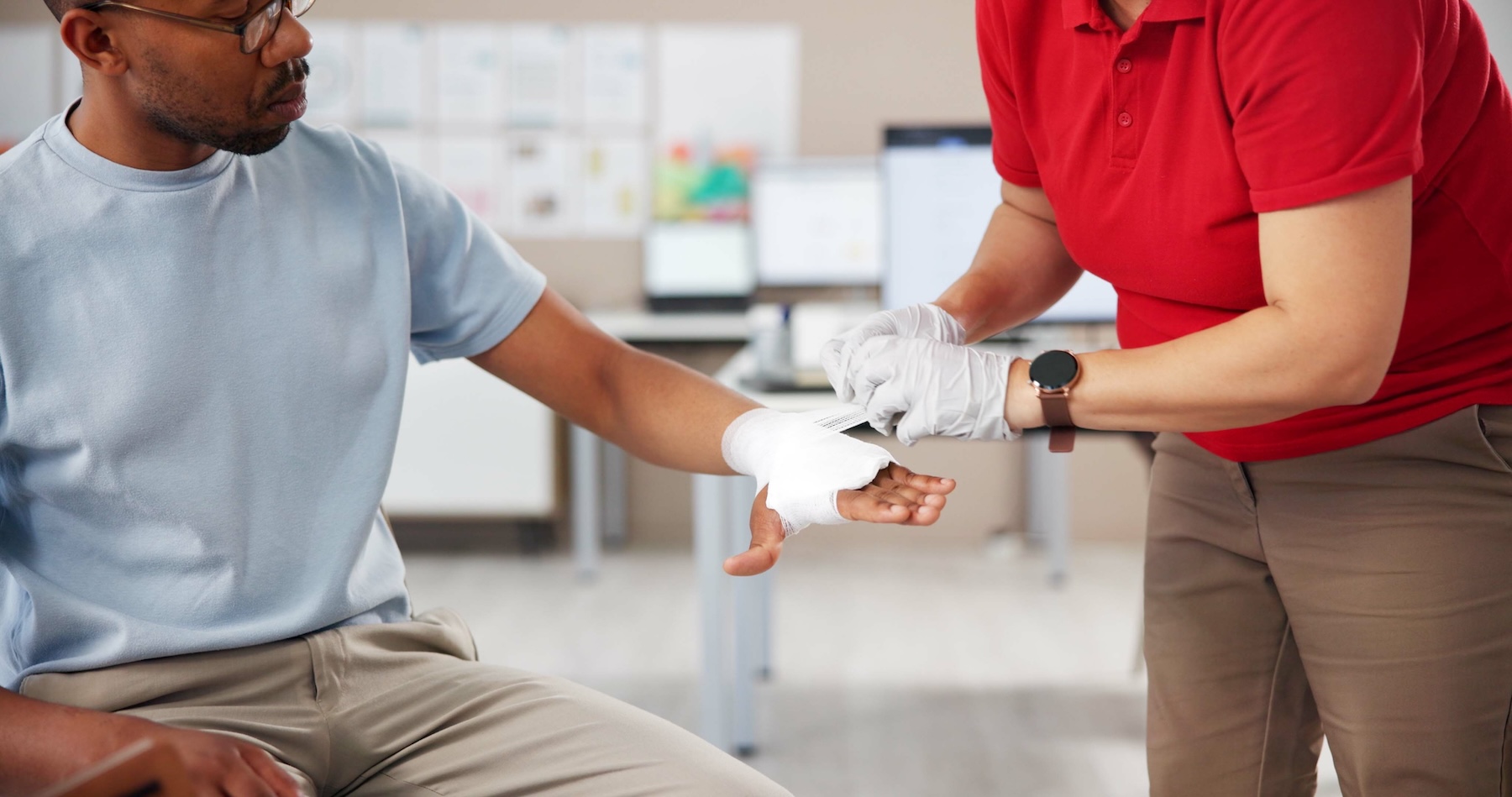 Urgent care professional wrapping patients hand in bandages due to a sprain