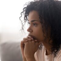 Close up side profile view of pensive young woman thinking of potential STD concerns