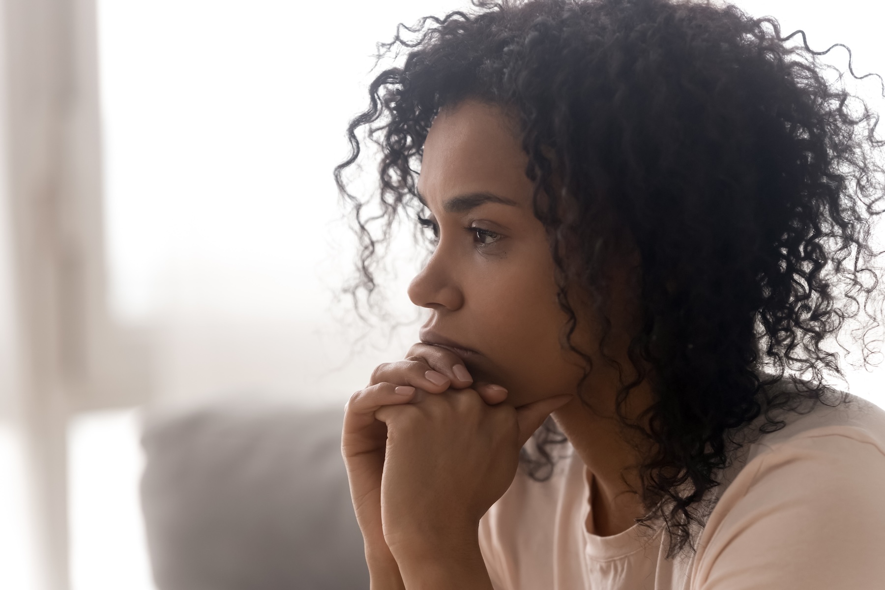 Close up side profile view of pensive young woman thinking of potential STD concerns